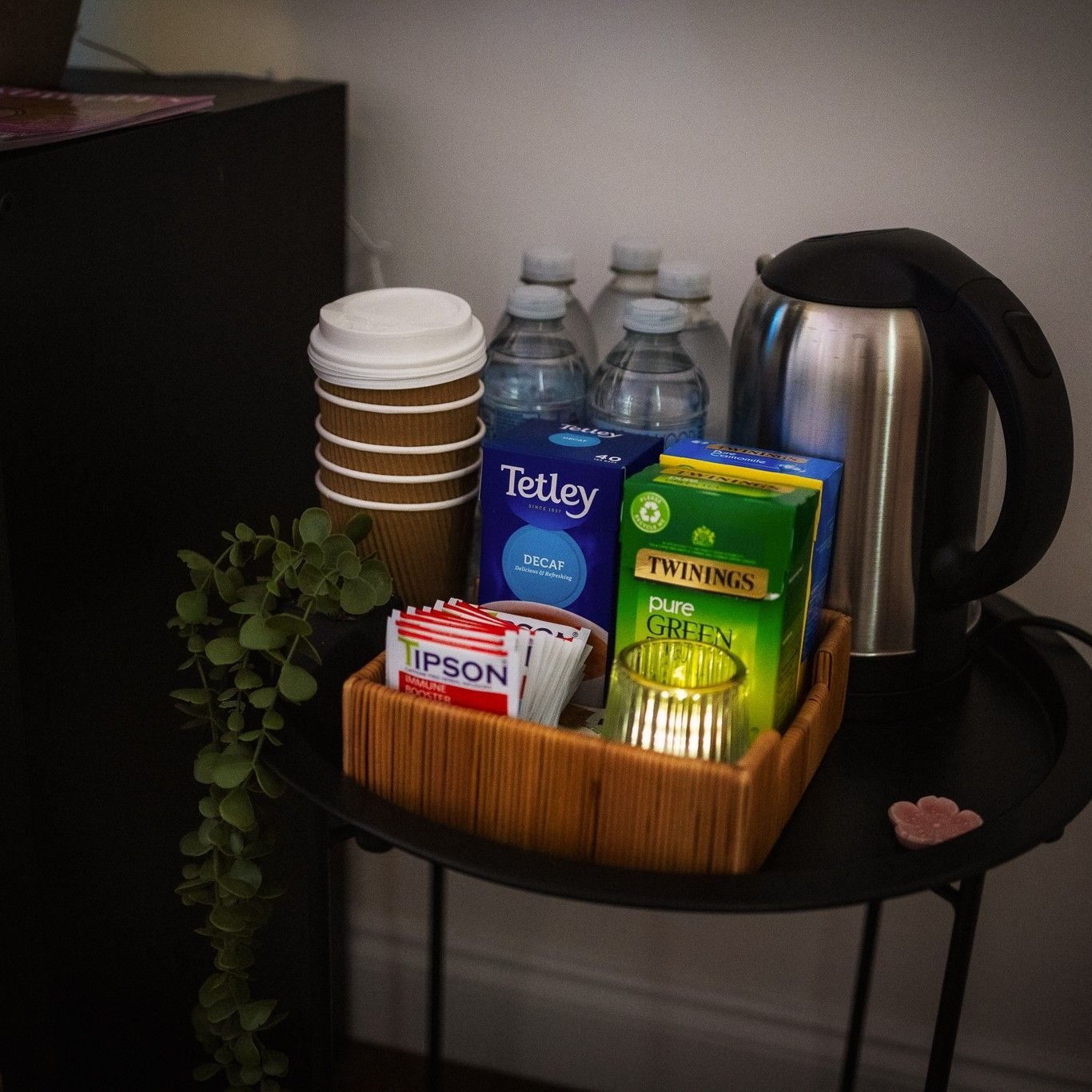 The refreshments table with cups, a kettle and a basket of teas